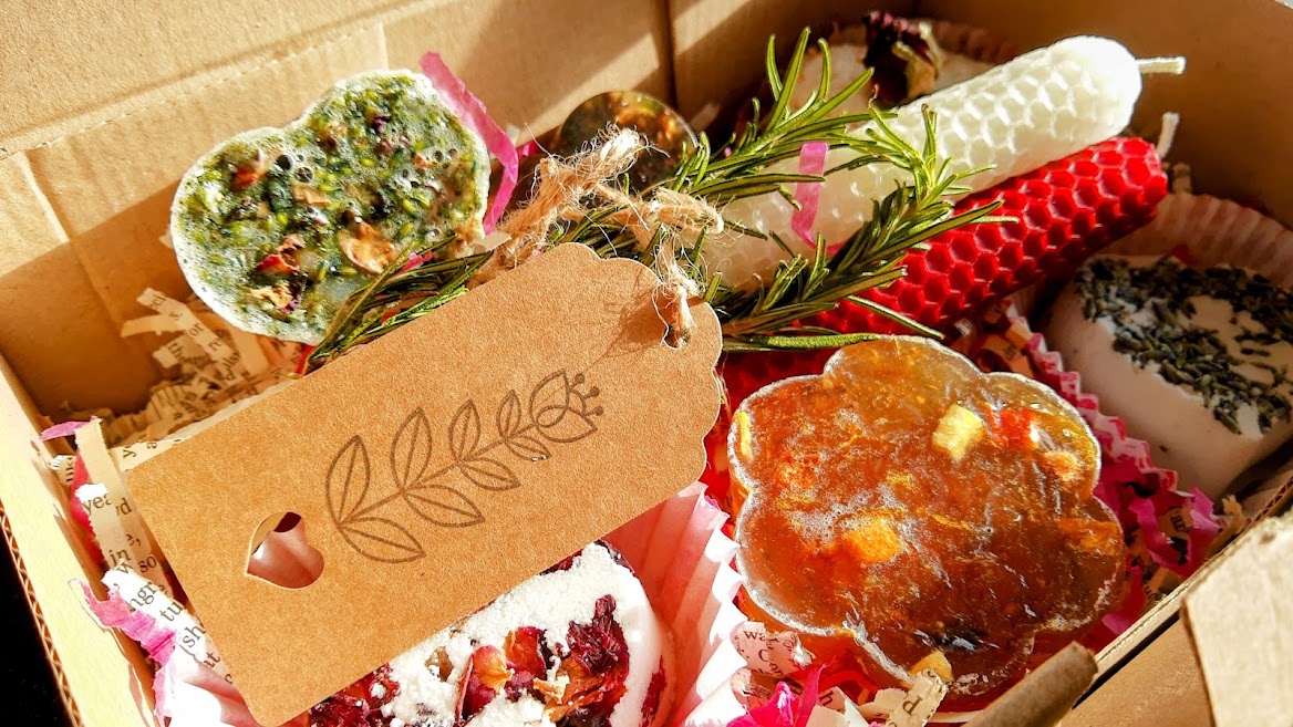 Box containing soaps, bath bombs and rolled beeswax candles.